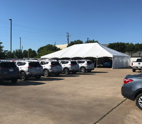 Vehicles at a Texas automotive repair location offering professional hail damage repair support.