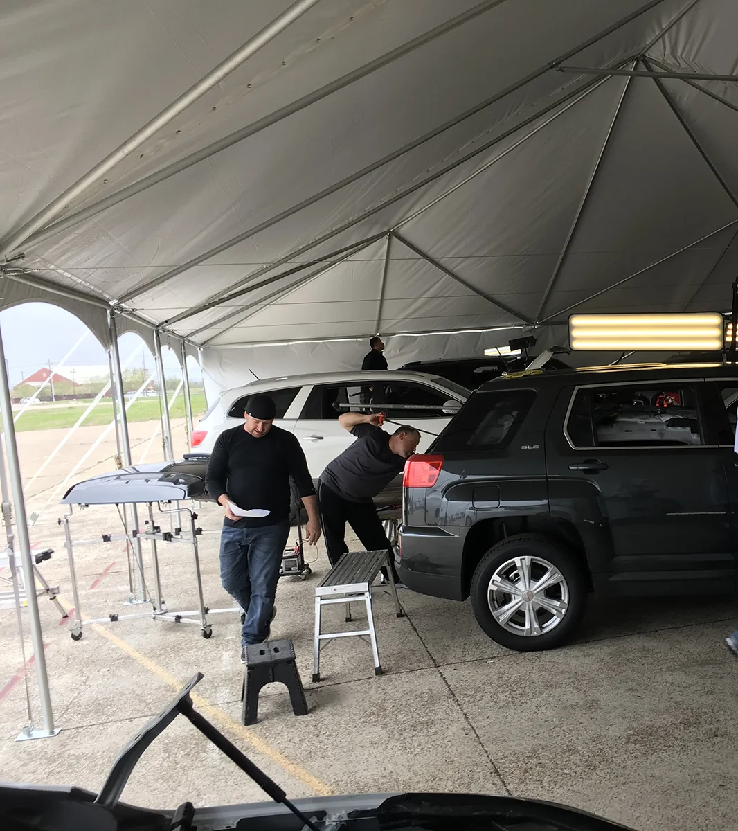 Technicians performing dent repair