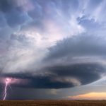 Supercell thunderstorm with lightning bolt and dark storm clouds