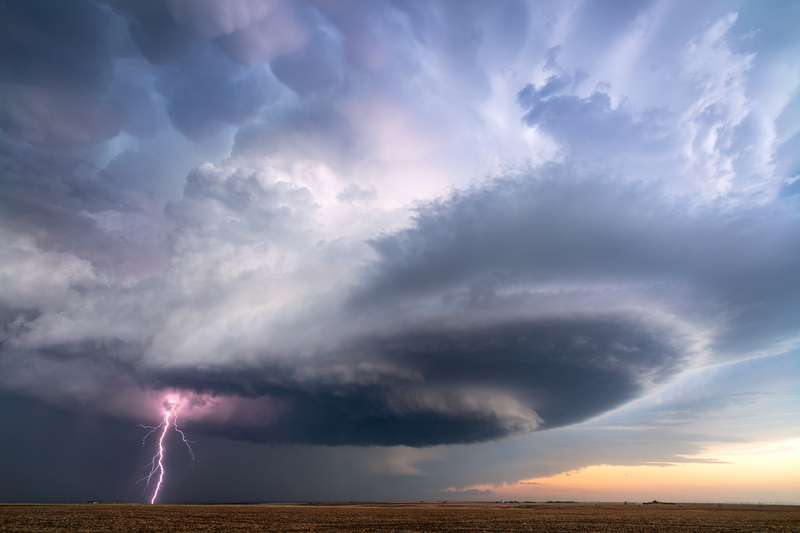 Supercell thunderstorm with lightning bolt and dark storm clouds