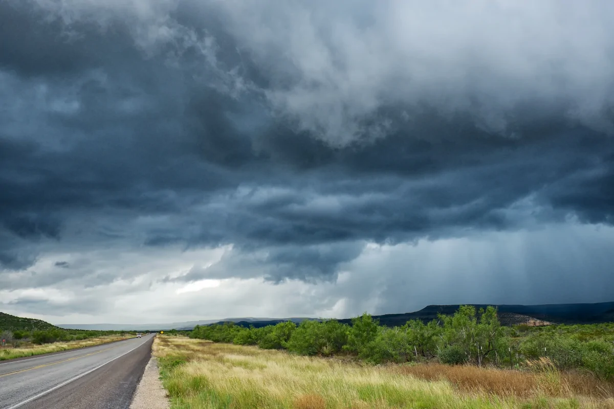 Dark storm clouds forming over a rural Texas road