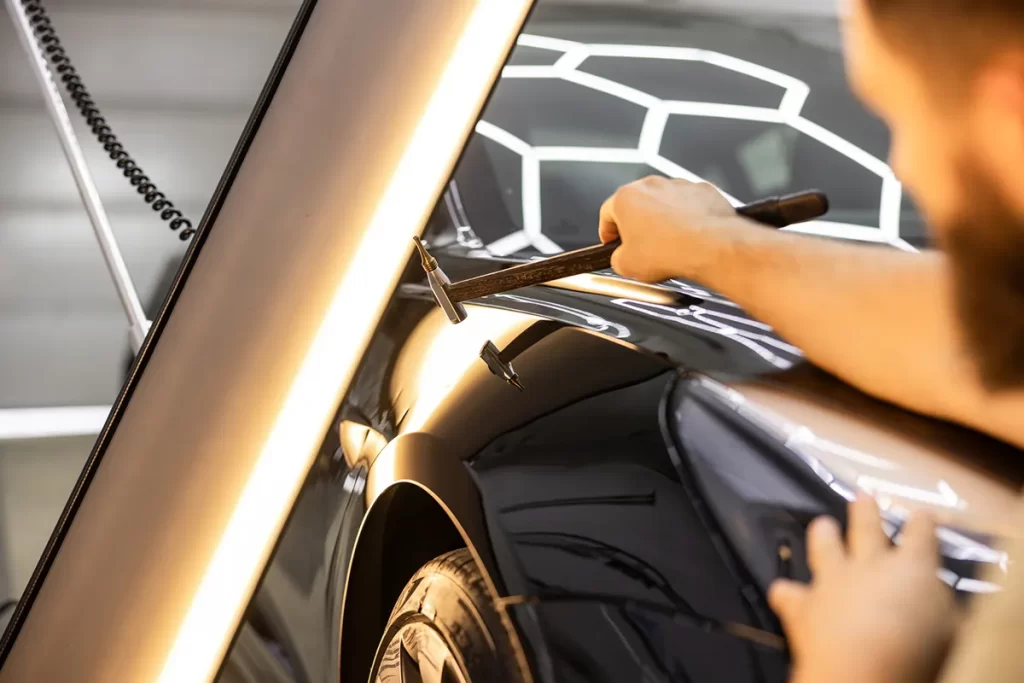hail repair technician working on vehicle