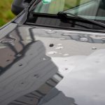 black car with hail dents